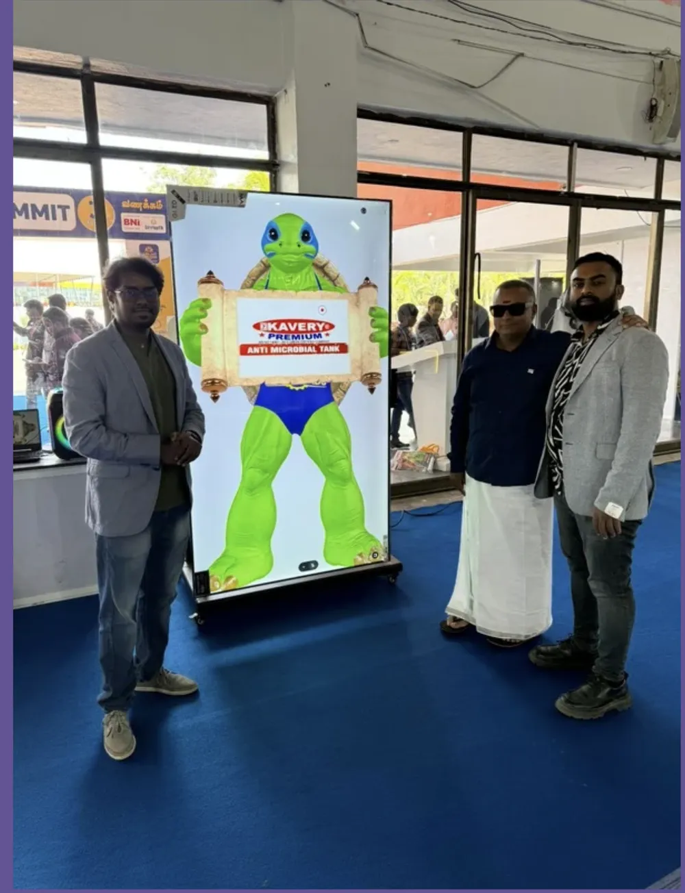 Visitors posing with a brand mascot character on a display at the Jubilant 2026 expo