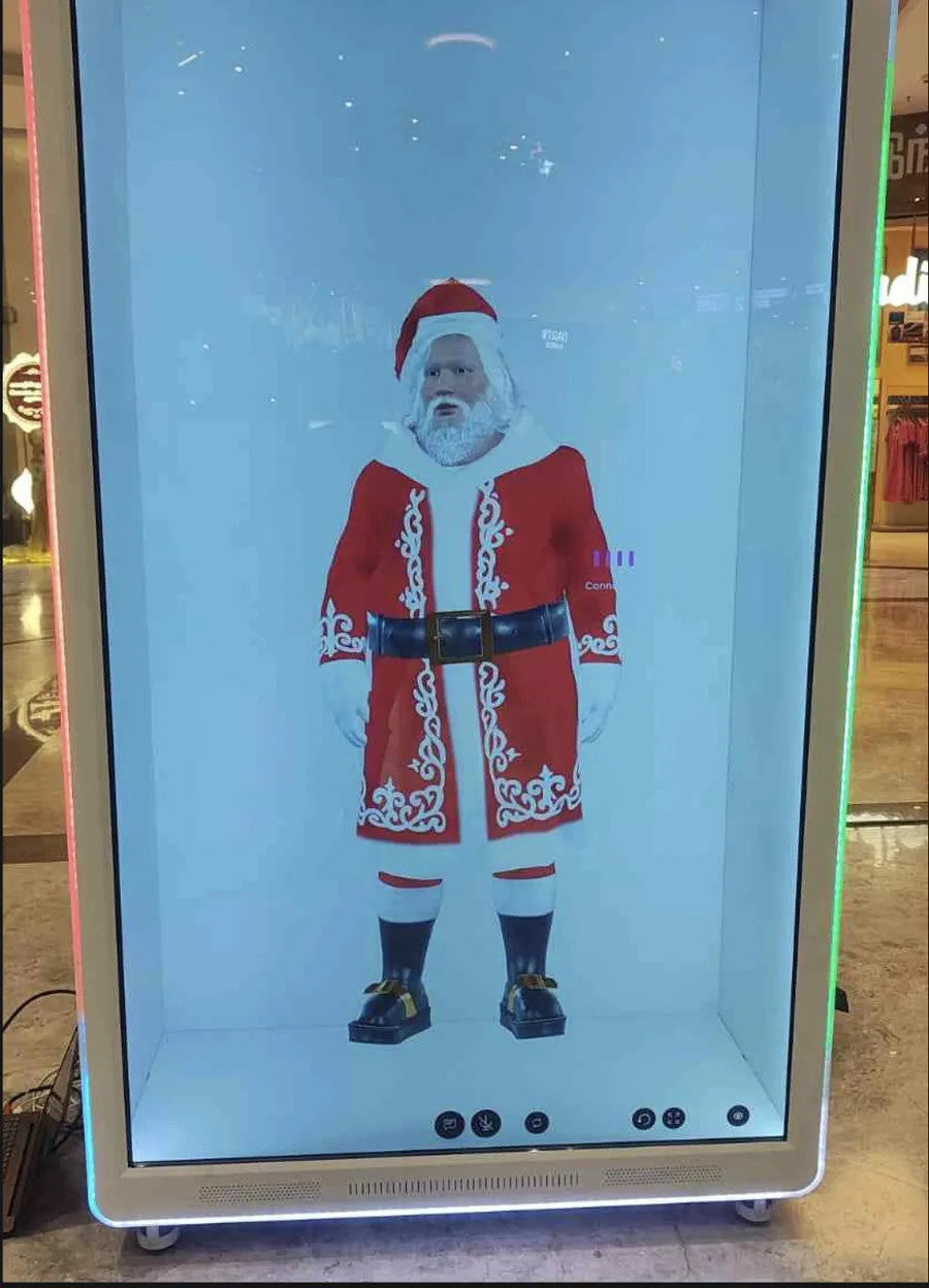 A full-height hologram unit showing a Santa character on a cinema corridor at Phoenix Mall, Chennai